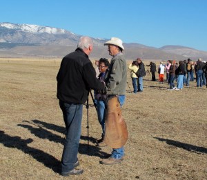 James Settlemeyer, in the chaps,   talking to a constituent