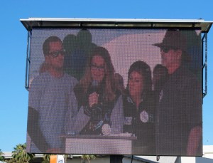 Nicole Hostert greeting the crowd with her family around her.