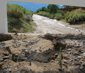 Looking west at some erosion and the same mud laden ditch