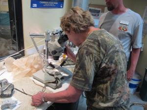 Shirley is checking out some microscopic material that will eventually be teased out of its encasement.