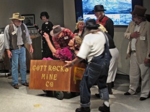 Peachy comes to and is helped out of the cart and into a chair