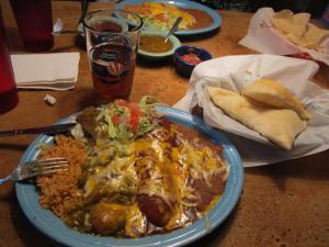 A dish of chile rellenos with the sopapillas on the side.