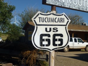 An old Route 66 sign in front of an abandoned motel.