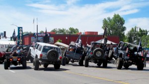 This looks like a multi-vehicle pile up but they are demonstrating their driving skills for the parade judges sitting under the canopy on the right. The Sierra Stompers to first place for a non-service club entry.