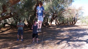 Dalan brought some gymnastics rings that his dad set up in a nearby tree. He did some tricks on them and made it look so easy.